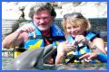Goldie Hawn Rocks a Red Swimsuit at Age 67, Feeds Dolphins With Kurt Russell